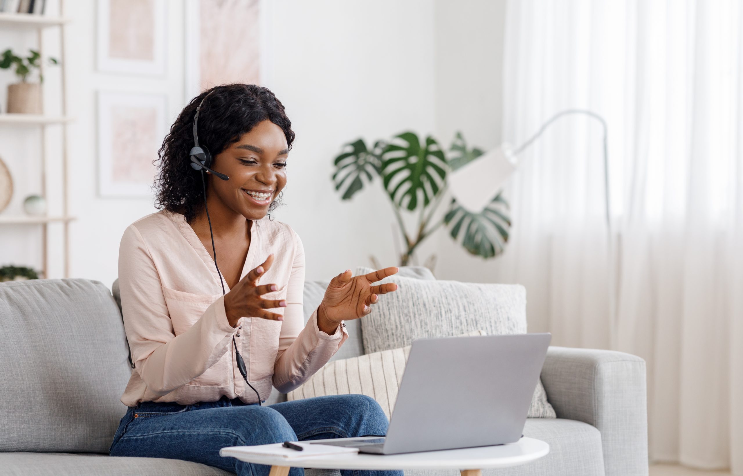 AdobeStock_179282012_Preview A professional woman speaking during a virtual meeting for a listening and communication coaching call